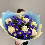 A bouquet of delicate roses and bright irises